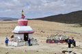 Dorchen, Tibet, China, June, 18, 2018. Pilgrims near the white Buddhist stupa at the beginning of the Cora around Kailas