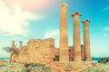 Doric temple of Athena Lindia on Acropolis of Lindos Rhodes, Greece. Front view of columns and walls. near the tree Royalty Free Stock Photo