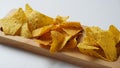 Doritos is an American brand of flavored tortilla chips. Corn chips doritos spiced on a a wooden board Royalty Free Stock Photo