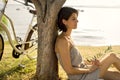 Dormant woman in love waiting under an olive's tree