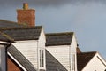 Dormer roof windows. Loft structures on modern town house buildings