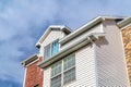 Dormer and upper floor exterior of a townhouse against clouds and blue sky Royalty Free Stock Photo