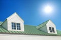 dormer with windows on metal sheet roof with blue sky and sunshine Royalty Free Stock Photo