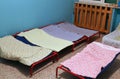 Dormitory with small beds for children in a preschool