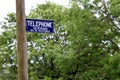 Dorset, UK - May 31st 2016: Vintage British telephone and telegram sign on a traditional wooden pole.