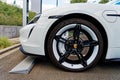 side view closeup of Porsche sports car wheel with black rim brake pads and white brake disc Royalty Free Stock Photo