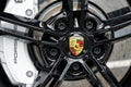 closeup of Porsche sports car wheel with black rim brake pads and white brake disc Royalty Free Stock Photo