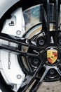 closeup of Porsche sports car wheel with black rim brake pads and white brake disc Royalty Free Stock Photo