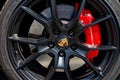 closeup of Porsche sports car wheel with black rim brake pads and red brake disc Royalty Free Stock Photo