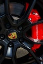 closeup of Porsche sports car wheel with black rim brake pads and red brake disc Royalty Free Stock Photo