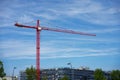 Red Crane at construction site with some building scaffold
