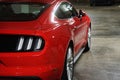 side back view of red sport ford mustang gt, underground car park with white shiny lights Royalty Free Stock Photo