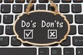 Dos and Donts message on chalkboard on a keyboard