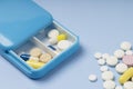 Daily dosage of medication in blue pill dispenser Royalty Free Stock Photo