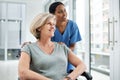 A dose of good help inspires better health. a young nurse caring for a senior woman in a wheelchair.