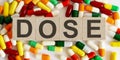 DOSE medicine words on the wooden block.Healthcare conceptual