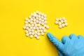 Dose of tablets. Gloved hand counting down pills Royalty Free Stock Photo
