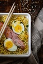 Doshirak fast food close-up. Instant noodles with egg, sausages and spices. Homemade ramen. Traditional Chinese food. Top view Royalty Free Stock Photo