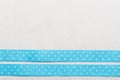 Dotted blue ribbon frame on white cloth