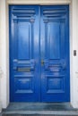 Double antique front doors painted in a glossy cobalt blue paint Royalty Free Stock Photo