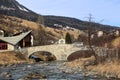 The double arch stone bridge over the river Julia in the Swiss alps village Savognin Royalty Free Stock Photo