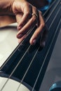 Double bass. Hands playing contrabass player musical instrument. Royalty Free Stock Photo