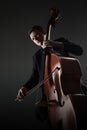 Double bass player contrabass playing with bow Royalty Free Stock Photo