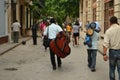 Double Bass Player walking through old Havanna Royalty Free Stock Photo