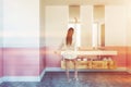 Woman near double bathroom sink