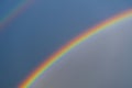 Double, beautiful, multi-colored rainbow on blue sky after summer downpour Royalty Free Stock Photo