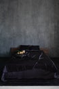 double bed with flowers in the bedroom in the dark interior room Royalty Free Stock Photo