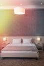 The double bed in the hotel room has a stylish interior. Lamps with lampshades Royalty Free Stock Photo