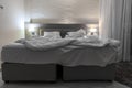 Double bed hotel room with messed bed night light Royalty Free Stock Photo