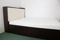 Double bed with lifting mechanism and mattress. The white mattress. Large bright bed Royalty Free Stock Photo