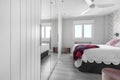 Double bedroom with beautiful decoration in hardwood, white fitted wardrobes, Royalty Free Stock Photo