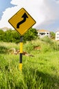 Double Bend Sign Among Grass
