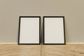 Double black realistic 3 evaluate photo frame standing on the floor leaning against the wall