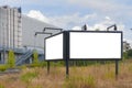 A double blank billboard with lights in a field