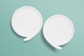 Two blank white speech bubble with border paper cut on grunge green paper background. Conceptual image about communication and