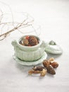 Double-boiled Matsuke and Morel Mushroom Soup served in a dish isolated on wooden board side view on grey background