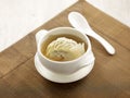 Double-boiled SharkÃ¢â¬â¢s Fin Dumpling Soup served in a bowl with spoon isolated on mat side view on grey background thailand fast