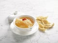 Double-boiled Supreme BirdÃ¢â¬â¢s Nest with Superior Broth served in a bowl side view on grey marble background