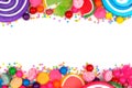 Double border of assorted colorful candies over white