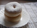 Double brown donuts with icing sugar