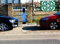 Double car recharging public station in street parking
