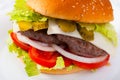 Double cheeseburger with beef, tomato, cheese, cucumber and lettuce Royalty Free Stock Photo