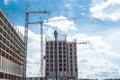 Double cranes working concrete building construction site, high-rise hotels, office building, skyscraper structure with precast Royalty Free Stock Photo