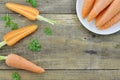 Double cut carrot and white plate with tasty ripe carrots on wooden table Royalty Free Stock Photo