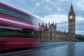 A double-decker bus crosses Westminster Bridge in London at sunrise. No people, nobody. Illuminated Big Ben tower Royalty Free Stock Photo