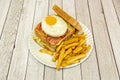 Double-decker sandwich with fried egg with yolk for dipping, grilled bread with butter, sliced cheese, fried bacon Royalty Free Stock Photo